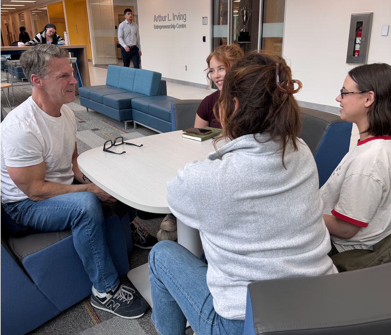 Dr. Darren Burke working with three women founders on a health and wellness venture.