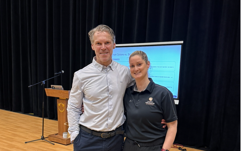 Dr. Darren Burke with former student Jill Kiley in an auditorium
